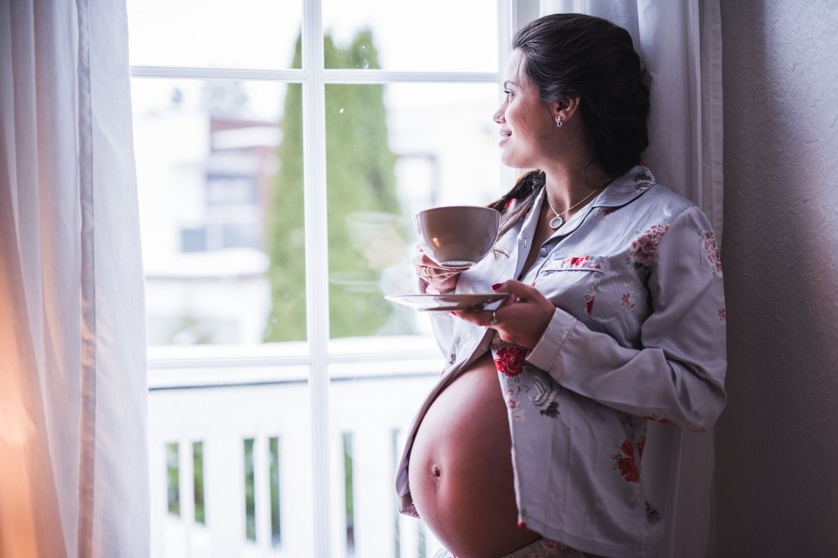 pregnant woman having a cup of coffee