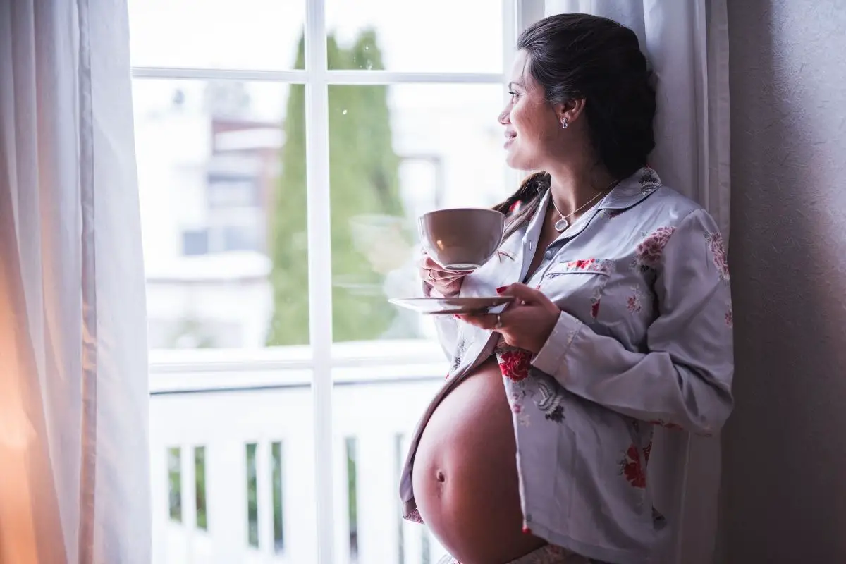 pregnant woman having a cup of coffee