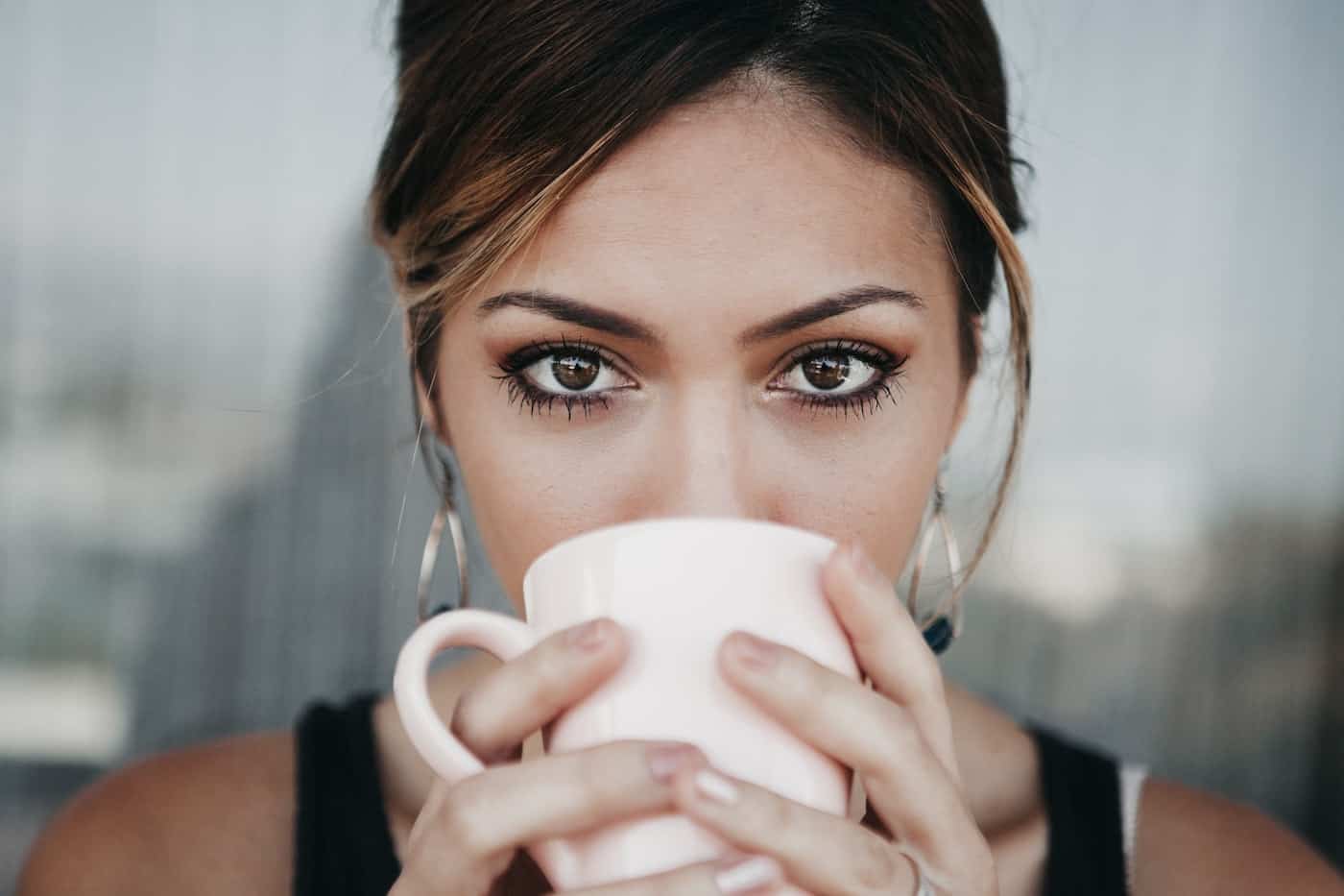 woman drinking caffeinated coffee