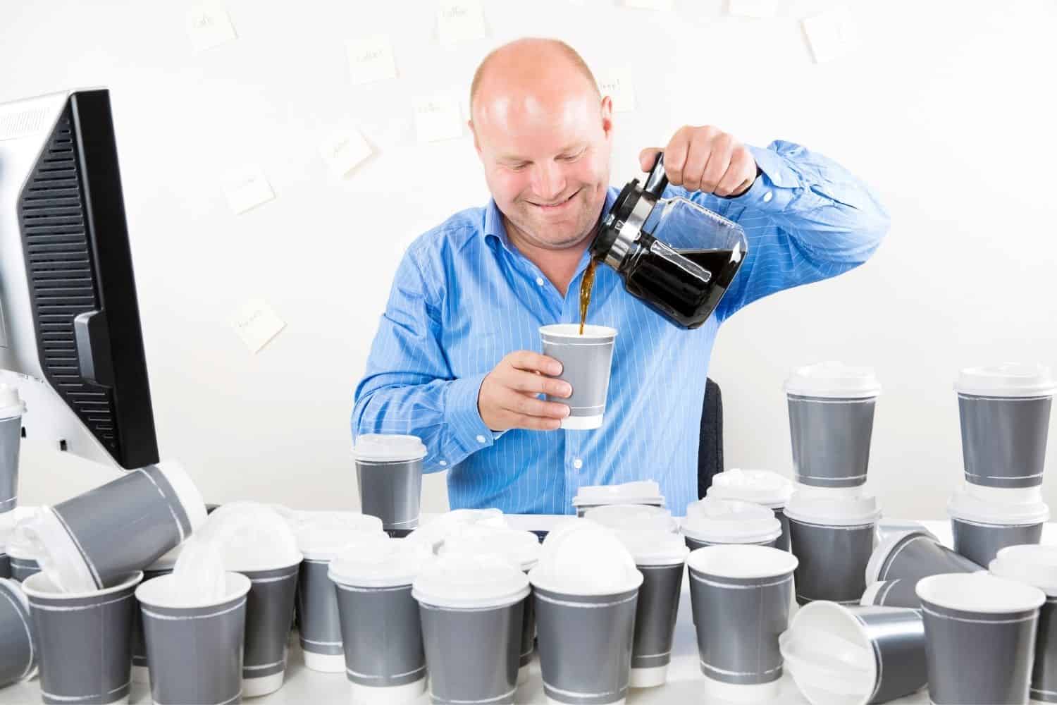 bald man drinking too many cups of coffee.