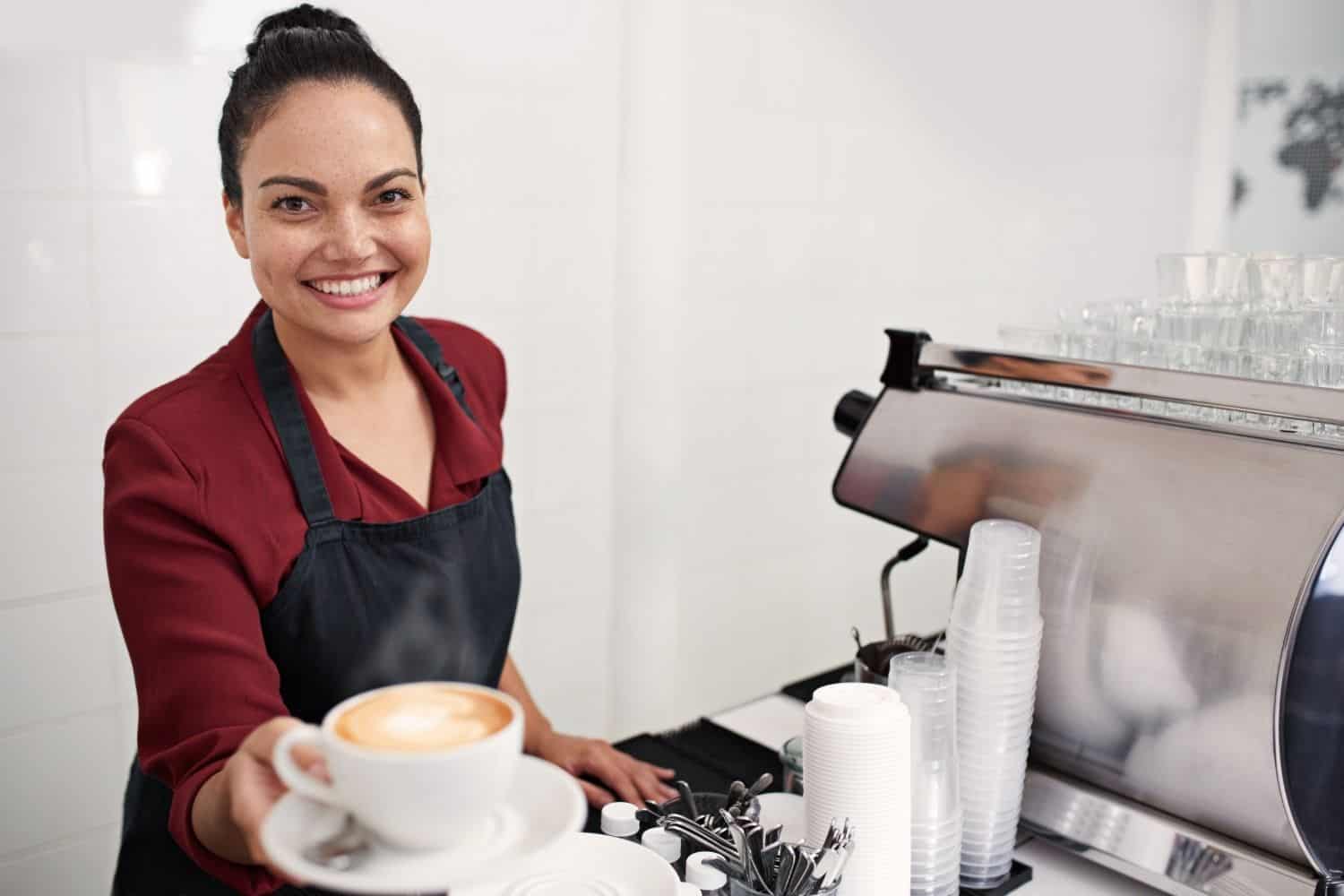 barista serving decaf coffee to a customer.