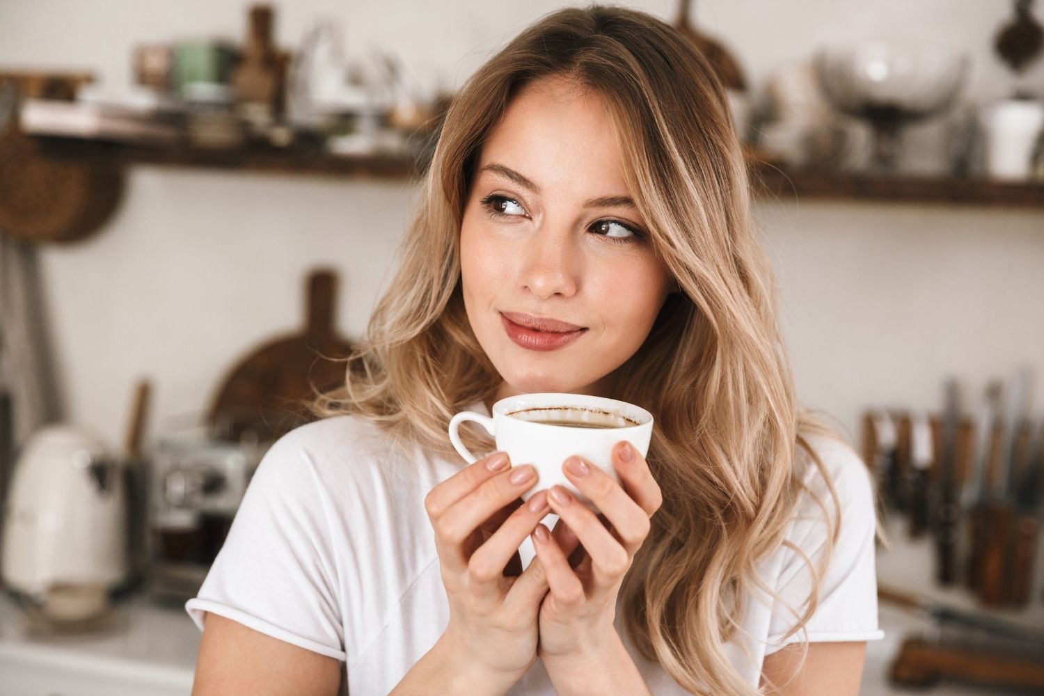 woman drinking coffee that is less acidic.