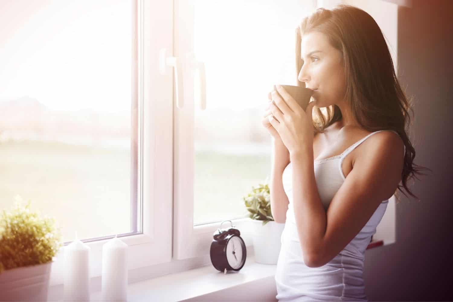 woman drinking her morning coffee to wake her up.