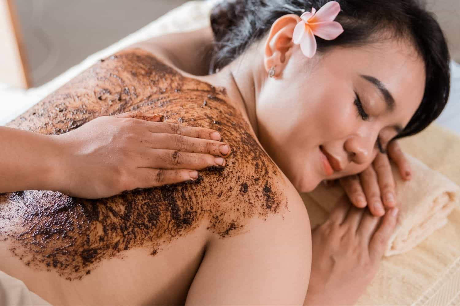 woman in spa salon having spa therapy coffee scrub.