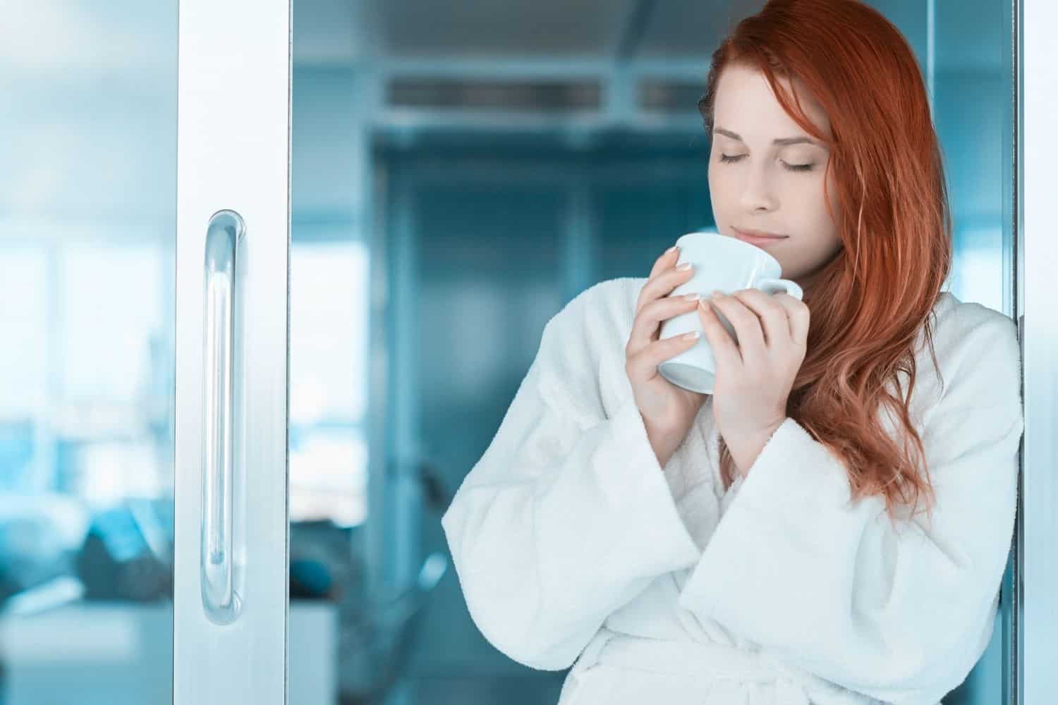 woman smelling her morning cup of coffee.