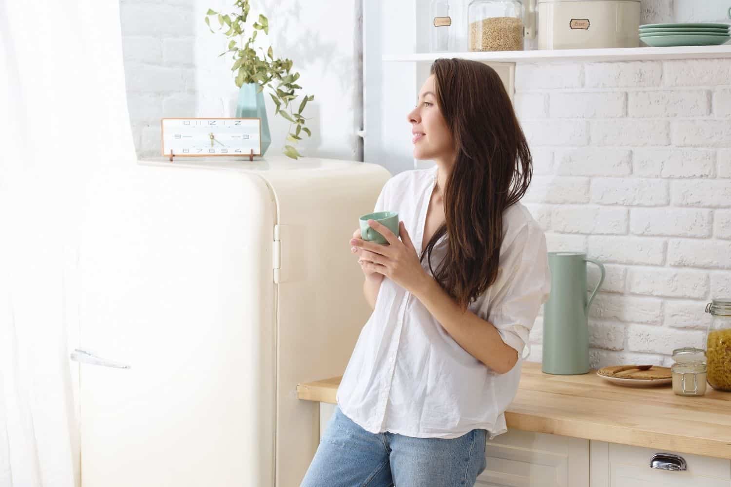 young woman enjoying a cup of light roast coffee.