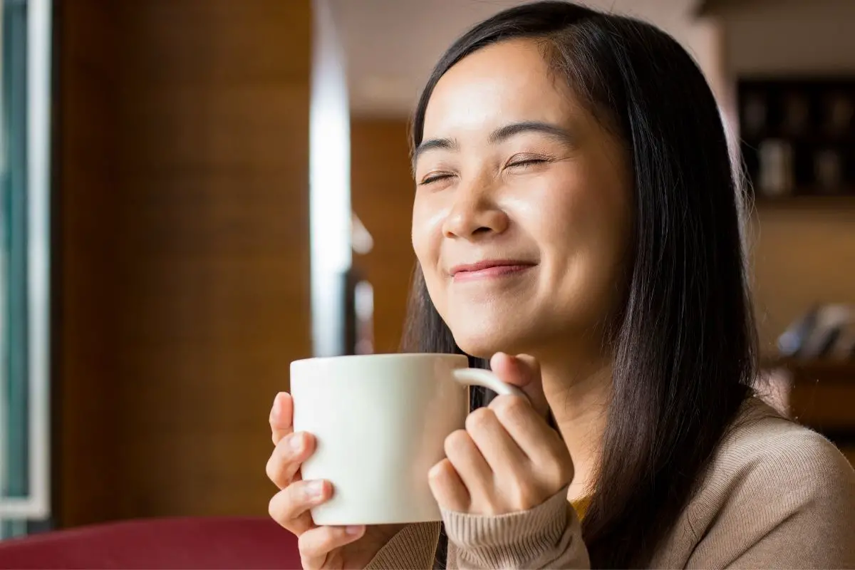 woman enjoying a nice cup of white coffee