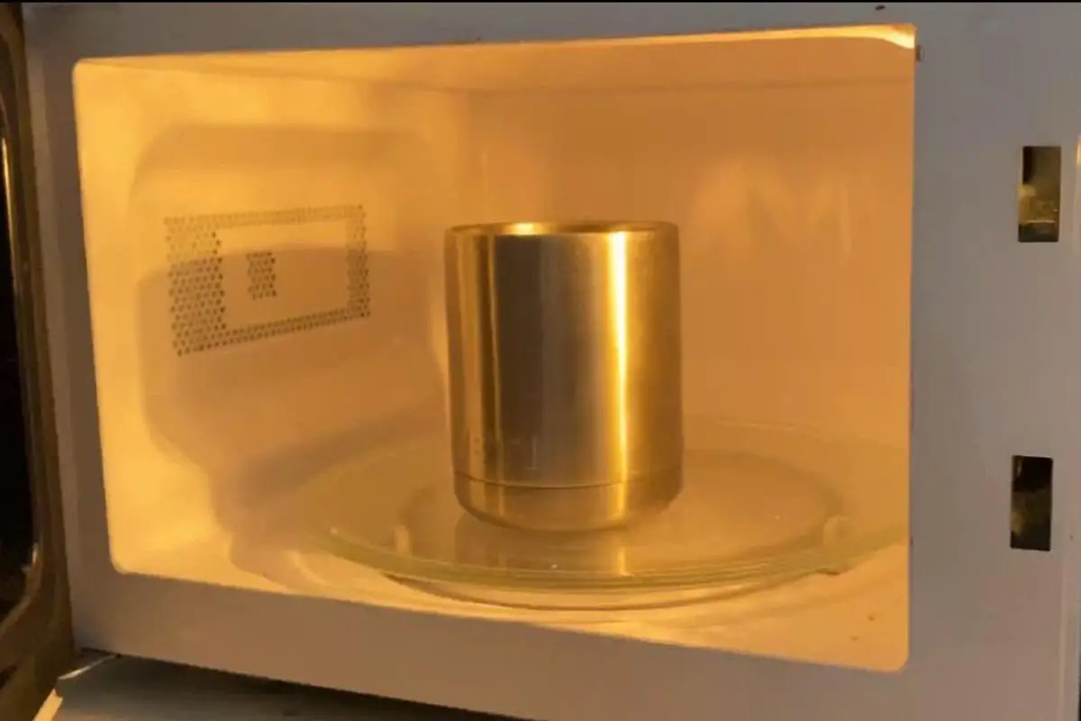 metal coffee cup in the microwave