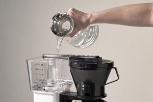 pouring water into expresso machine