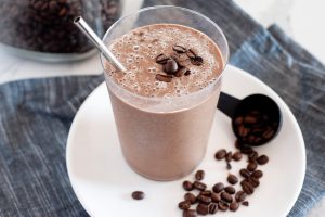 smoothie with straw and coffee beans