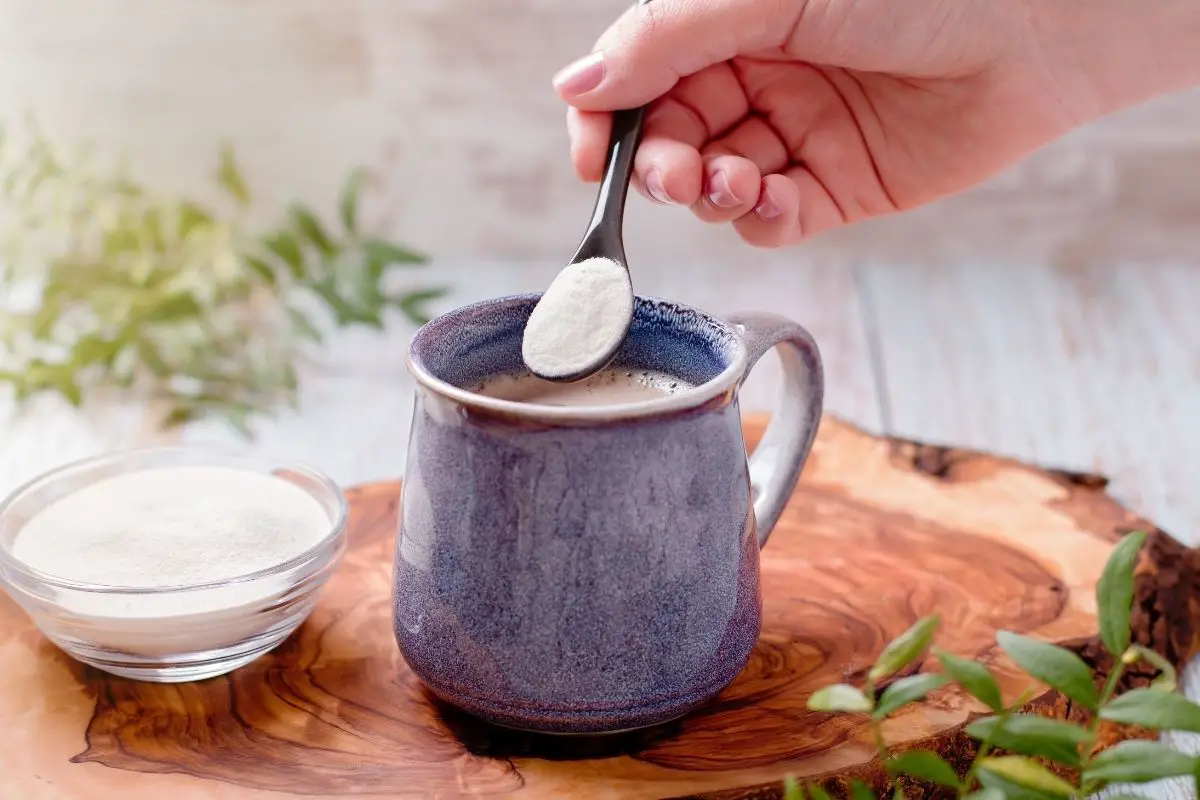 woman adding collagen to her morning coffee