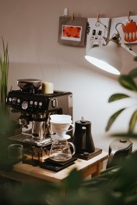 black and silver coffee maker on brown wooden table