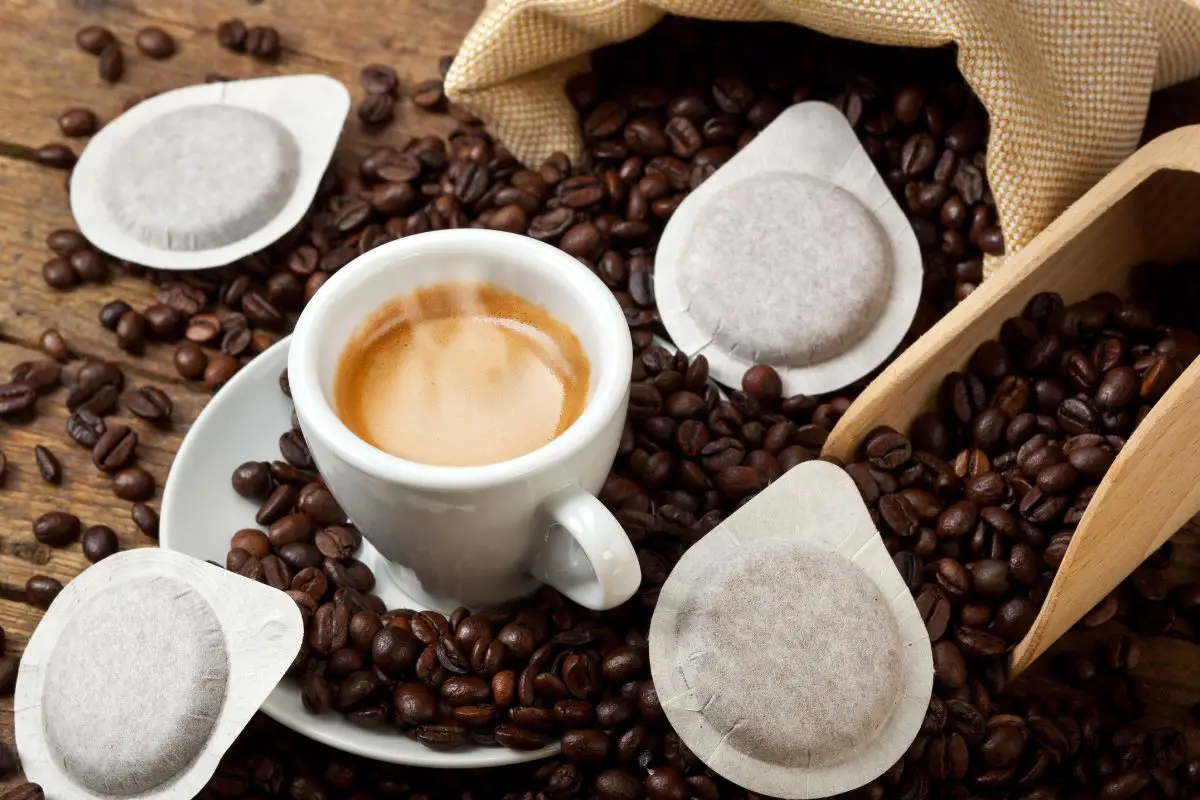 coffee cup with pods on rustic table