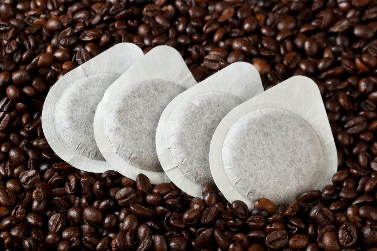 coffee pods placed on top of coffee beans