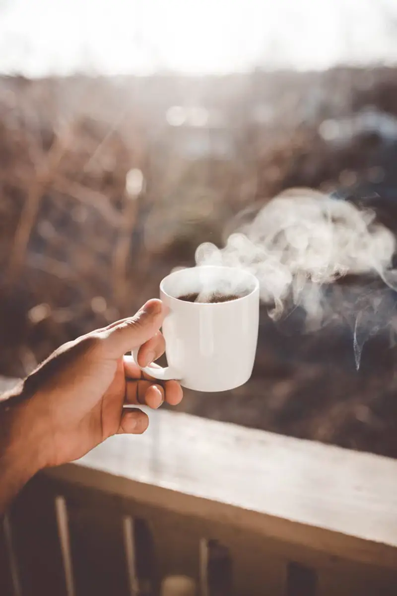 hot coffee cup in a person hand