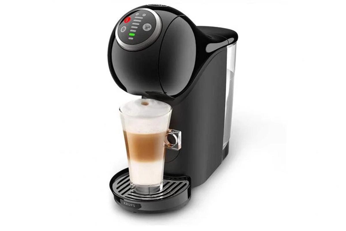 pouring coffee in white glass from coffee pod machine