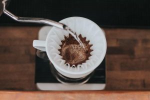 pouring hot water into white ceramic mug