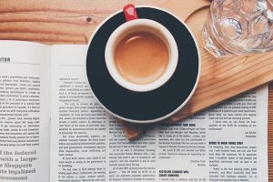 white coffee cup and open book