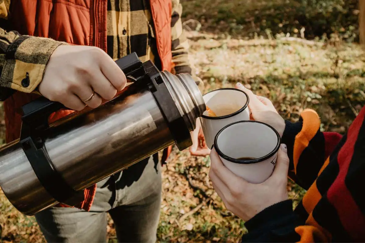 man pouring coffee from thermos